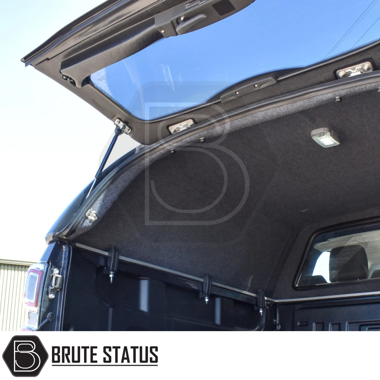 Isuzu D-Max Truckman RS Hardtop Canopy with solid rear window and remote locking, featuring grey carpeted lining, LED light, and mounting rails in an open truck cap.
