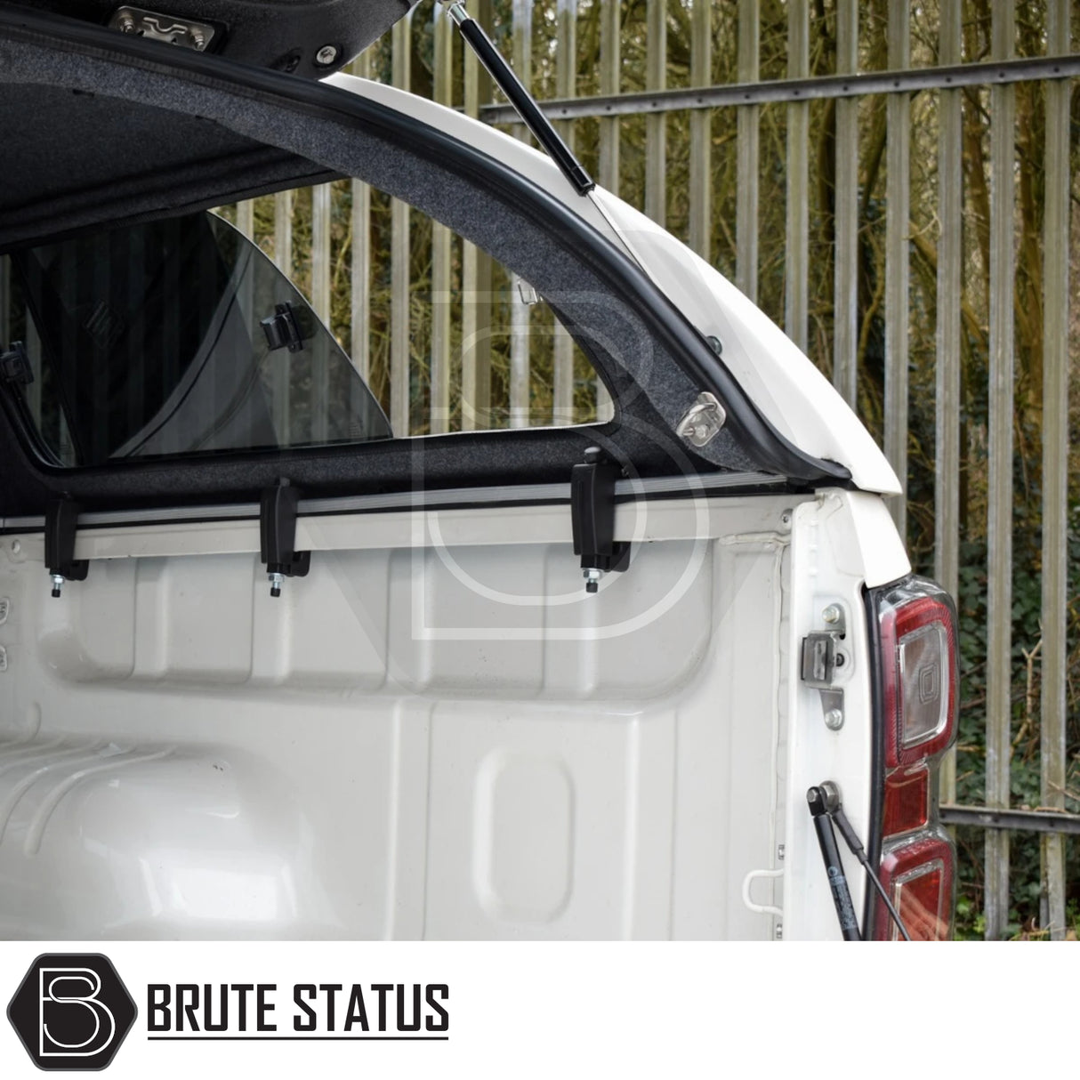 Isuzu D-Max  Truckman GLS Hardtop Canopy open, showcasing white truck bed, tinted windows, gas struts, and clamping brackets. Tail lights and latch hardware visible.