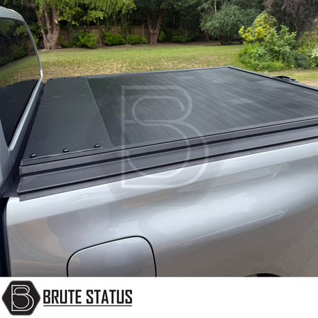 Black manual roller shutter for nissan navara D40 2005-2015 pickup truck. Durable, high-quality design for secure cargo protection and easy manual operation