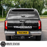 Mercedes X-Class with Truckman Grand Hardtop Canopy features remote locking, tinted windows, and tow hitch, showcasing enhanced storage and style. Watermarked Brute Status.