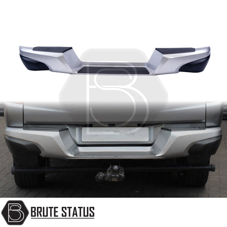 Silver rear bumper for 2015-2019 Mitsubishi L200, featuring a sleek factory-style finish, non-slip foot steps with drainage channels, and a durable, direct bolt-on design for easy installation and rugged use.