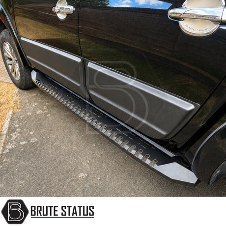 Matte Black heavy duty side panel protection fitted to Mitsubishi L200 Series 5 model pickup truck offroad 4x4 vehicle. Suitable for overlanding set ups, mounting hardware and brackets included. 