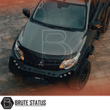 Mitsubishi L200 MK5 2015-2019 Heavy Duty Winch Front Bumper, featuring a matte black finish, LED lights, and space for a winch, parked on a brick surface.