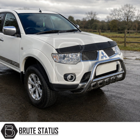 Front mounting heavy duty carbon stainless chrome steel nudge bull bar fitted to Mitsubishi L200 Series 4 pickup truck offroad 4x4. 