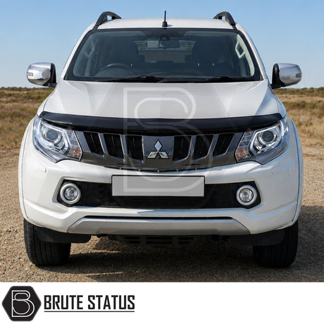 Premium black bonnet protector installed on a white Mitsubishi L200 Series 5 pickup truck with aerodynamic styling