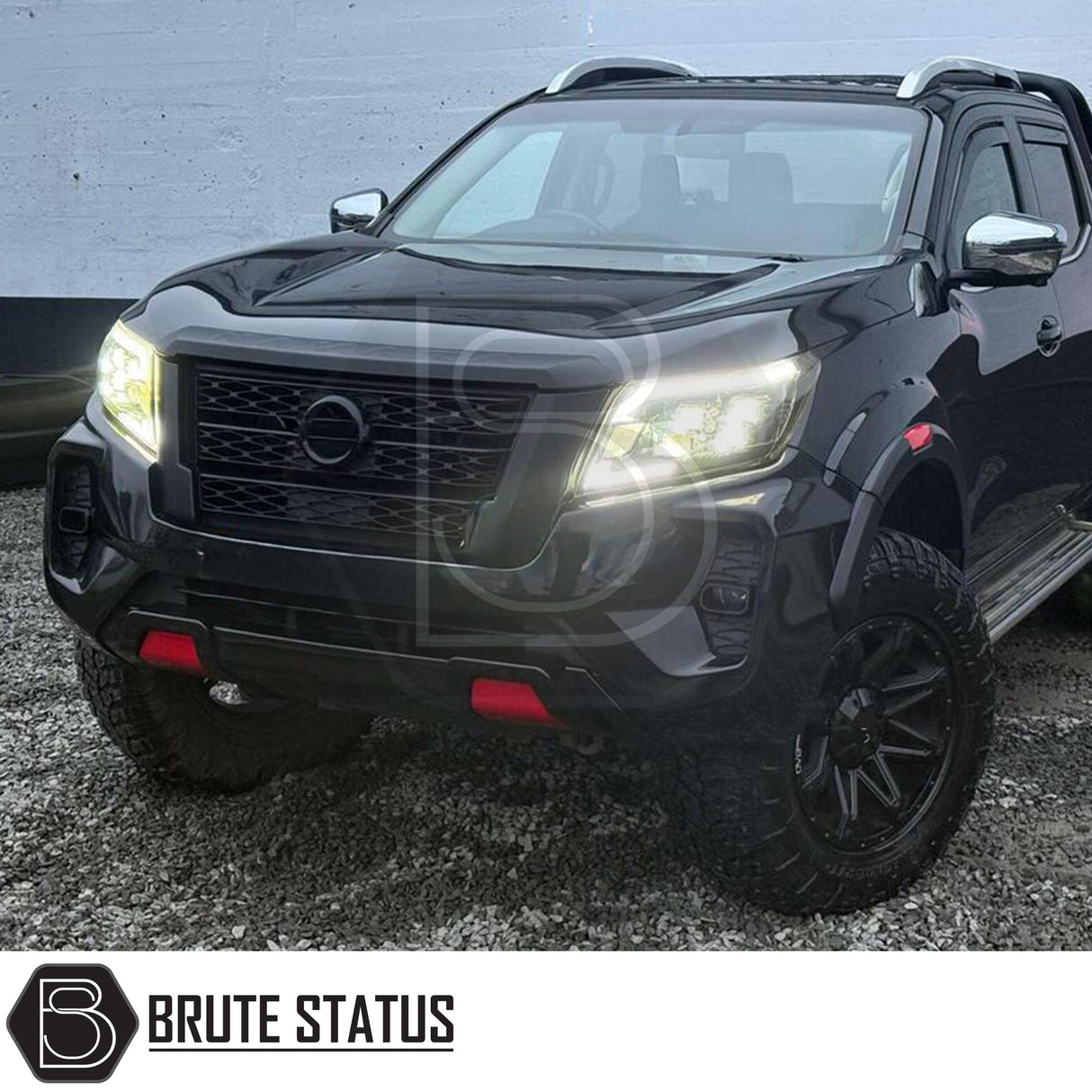 Nissan Navara NP300 2015-2022 Facelift Bodykit Upgrade, featuring a blacked-out grille, all-terrain tires, red tow hooks, enhancing the truck's rugged, modern appearance.