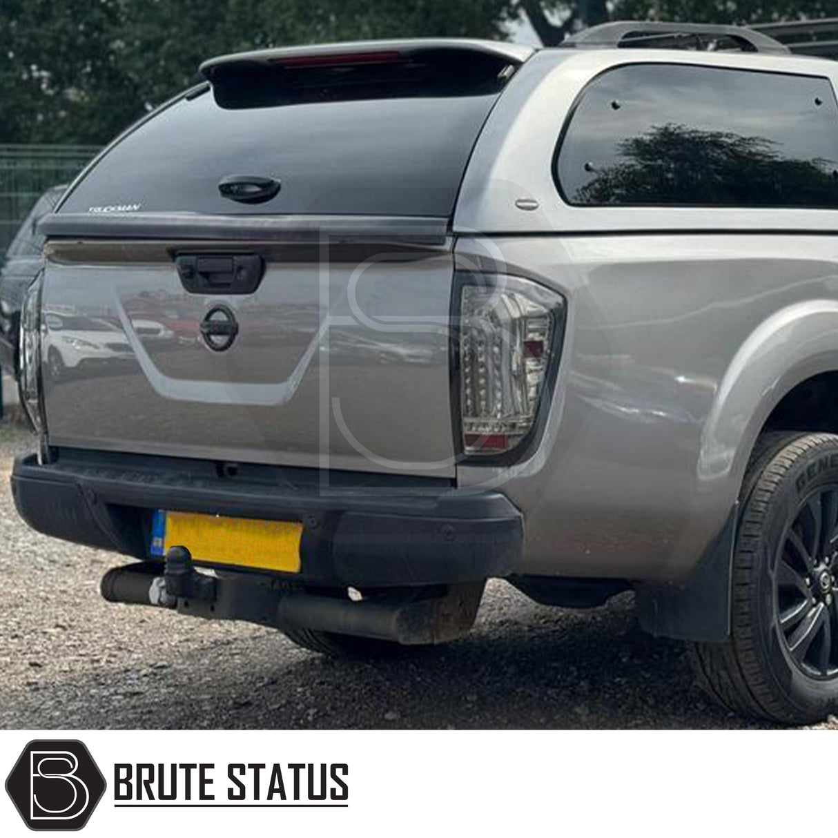 Black rear bumper for Nissan Navara NP300 (2015–2022), featuring a sleek factory-style finish, pre-drilled holes for OEM parking sensors, non-slip foot steps with drainage channels, and a durable, direct bolt-on design for easy installation and rugged use