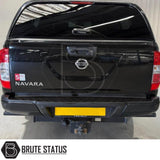Black rear bumper for Nissan Navara NP300 (2015–2022), featuring a sleek factory-style finish, pre-drilled holes for OEM parking sensors, non-slip foot steps with drainage channels, and a durable, direct bolt-on design for easy installation and rugged use