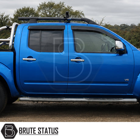 Front and rear wind rain deflectors fitted onto Blue Nissan Navara D40 pickup truck suitable for off roading and overlanding set ups. 