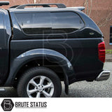 Rear view of Nissan Navara D40 with Truckman GLS hardtop canopy featuring tinted sliding windows, alloy wheel, and Brute Status logo.