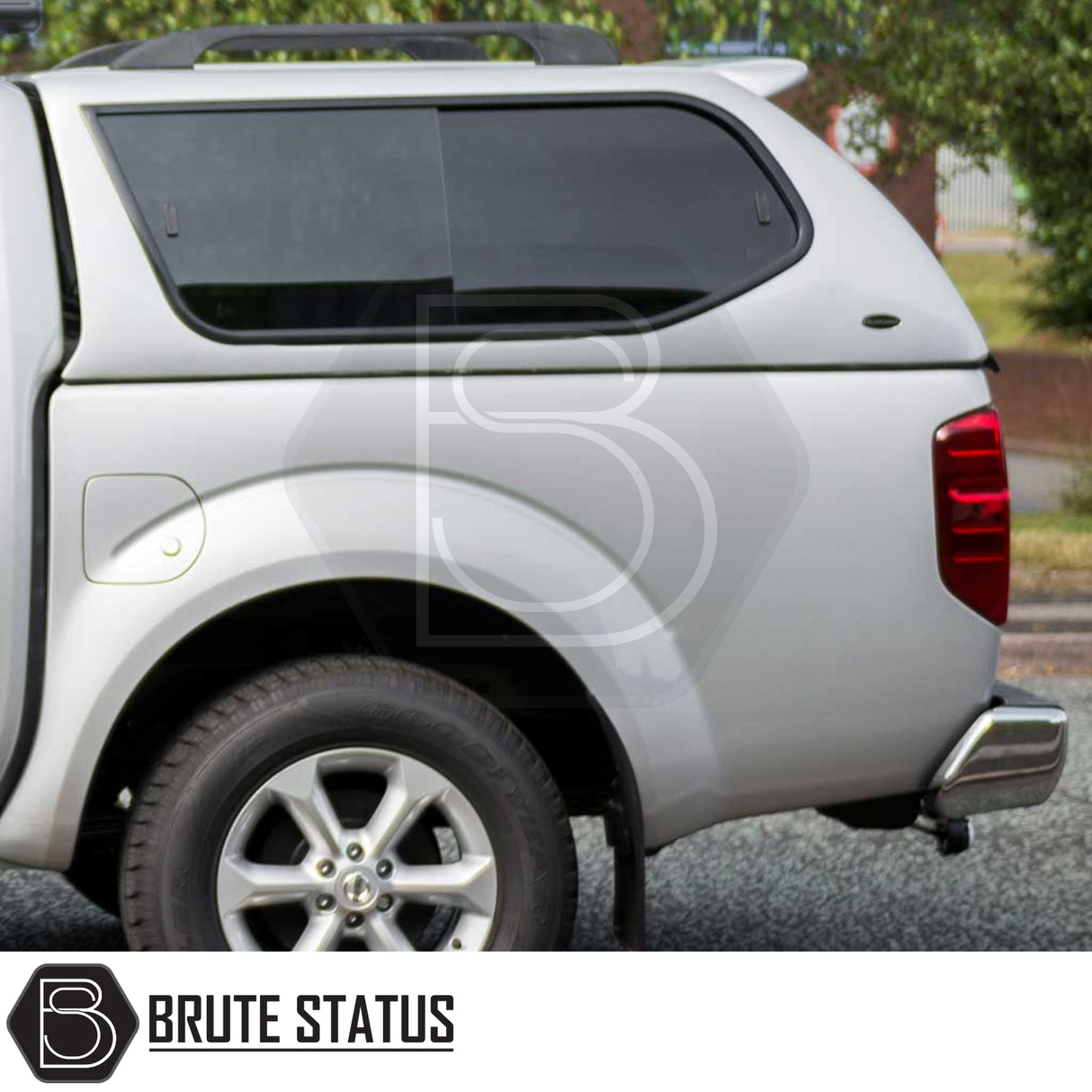 Nissan Navara 2005-2015 D40 Truckman GLS Hardtop Canopy with remote locking, showcasing tinted side window, rear wheel, alloy rim, and roof-rack bars.