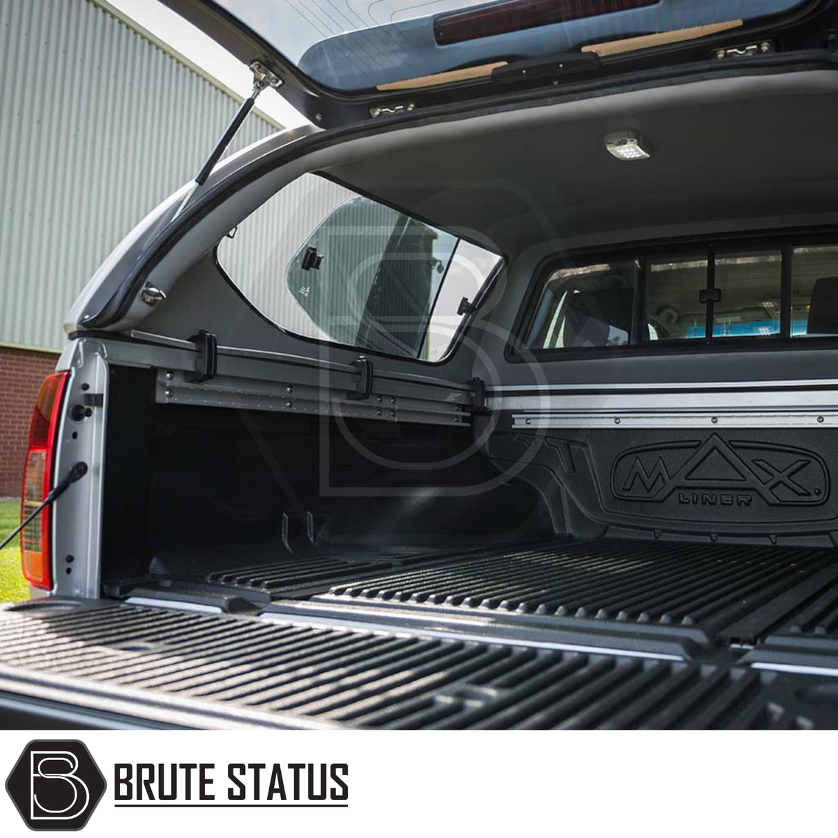 Nissan Navara 2005-2015 D40 Truckman GLS canopy with open tailgate, sliding windows, gas-strut hatch, and accessory rails, showcasing aftermarket storage and ventilation features.