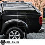 Nissan Navara 2005-2015 D40 Truckman Grand Hardtop Canopy with rear view showing tinted windows and Brute Status logo, showcasing secure and stylish storage.