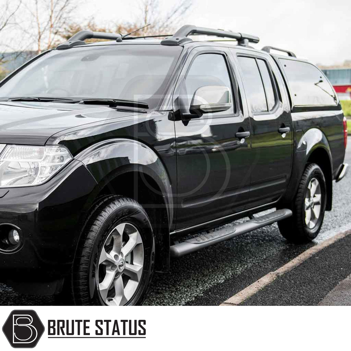 Nissan Navara 2005-2015 D40 Truckman Grand Hardtop Canopy with remote locking, featuring a sleek design, roof racks, side-step bars, alloy wheels, and all-terrain tires.