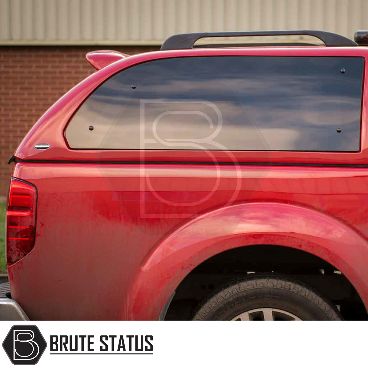 Rear view of a red Nissan Navara 2005-2015 D40 with Truckman Grand Hardtop Canopy featuring a cab-high design, tinted windows, and remote locking.