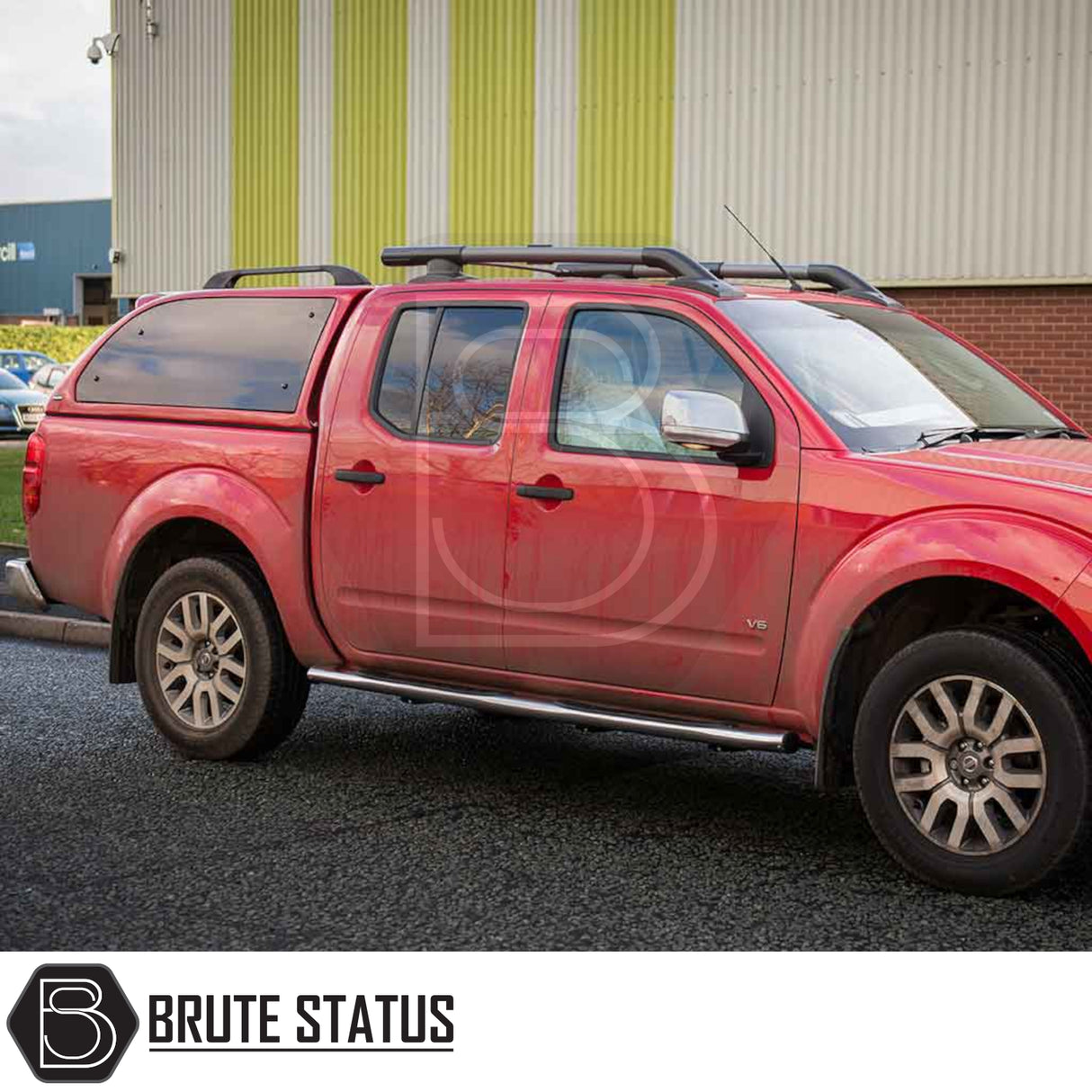 Nissan Navara D40 Truckman Grand Hardtop Canopy with remote locking, featuring roof bars, alloy rims, and a red canopy with pop-out tinted windows.
