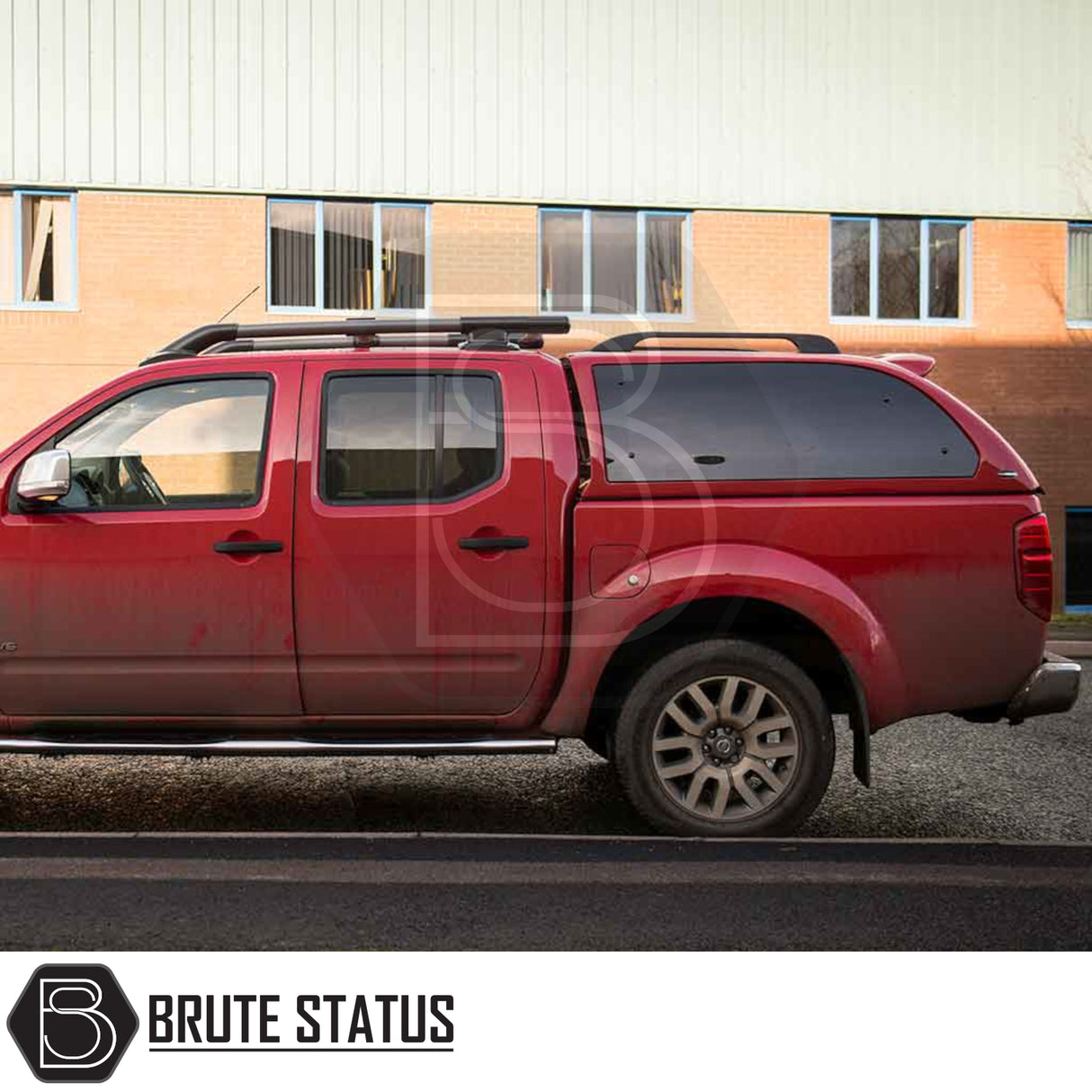 Nissan Navara 2005-2015 D40 Truckman Grand Hardtop Canopy with remote locking on red pickup; features stylish, cab-high design and pop-out tinted windows.
