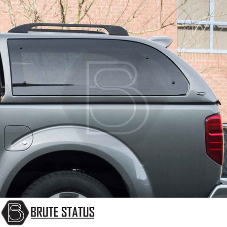 Nissan Navara 2005-2015 D40 Truckman Grand Hardtop Canopy with tinted windows and roof rack, showcasing sleek design and increased storage capacity.