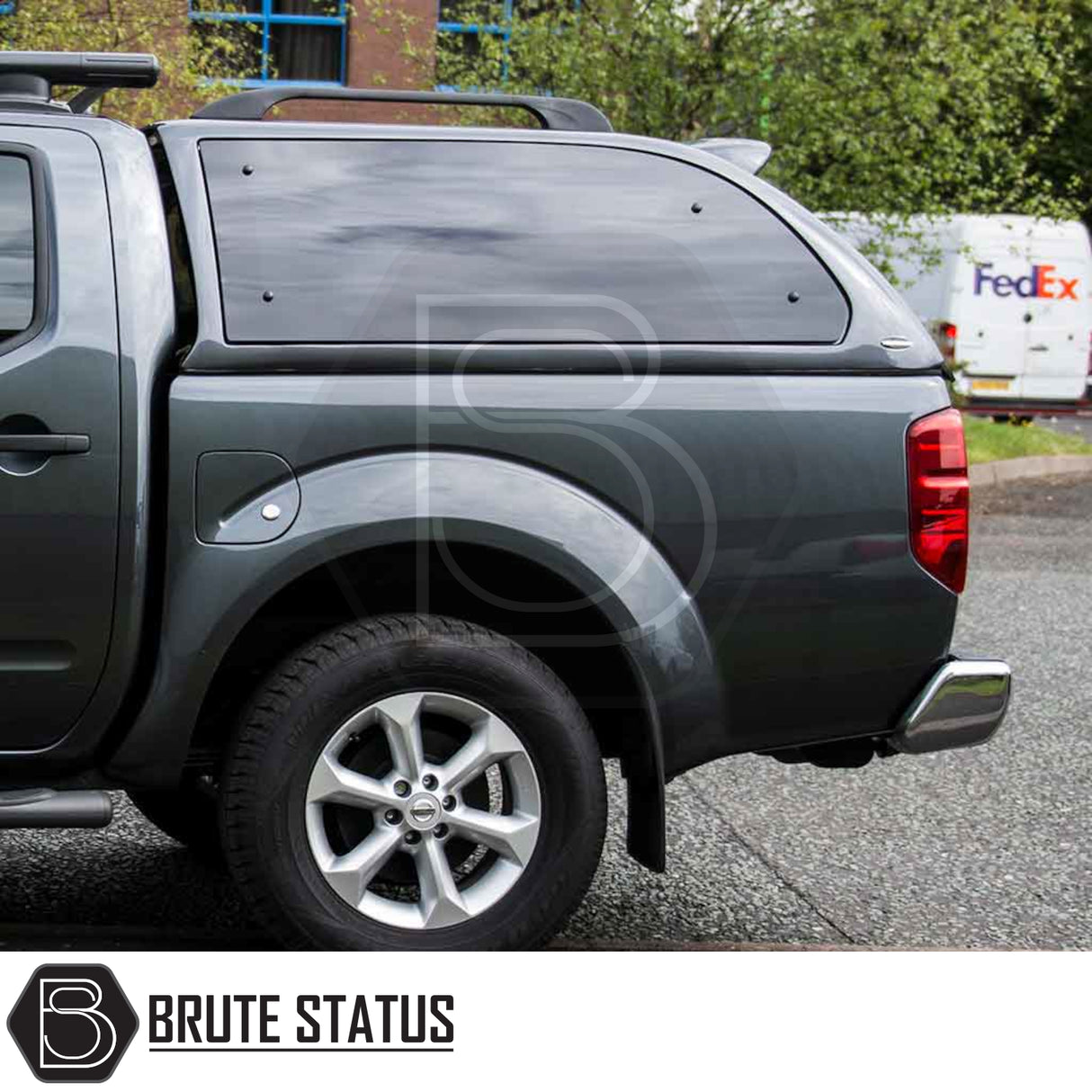 Rear view of a grey Nissan Navara 2005-2015 D40 featuring a Truckman Grand Hardtop Canopy with remote locking and tinted windows, enhancing storage and security.