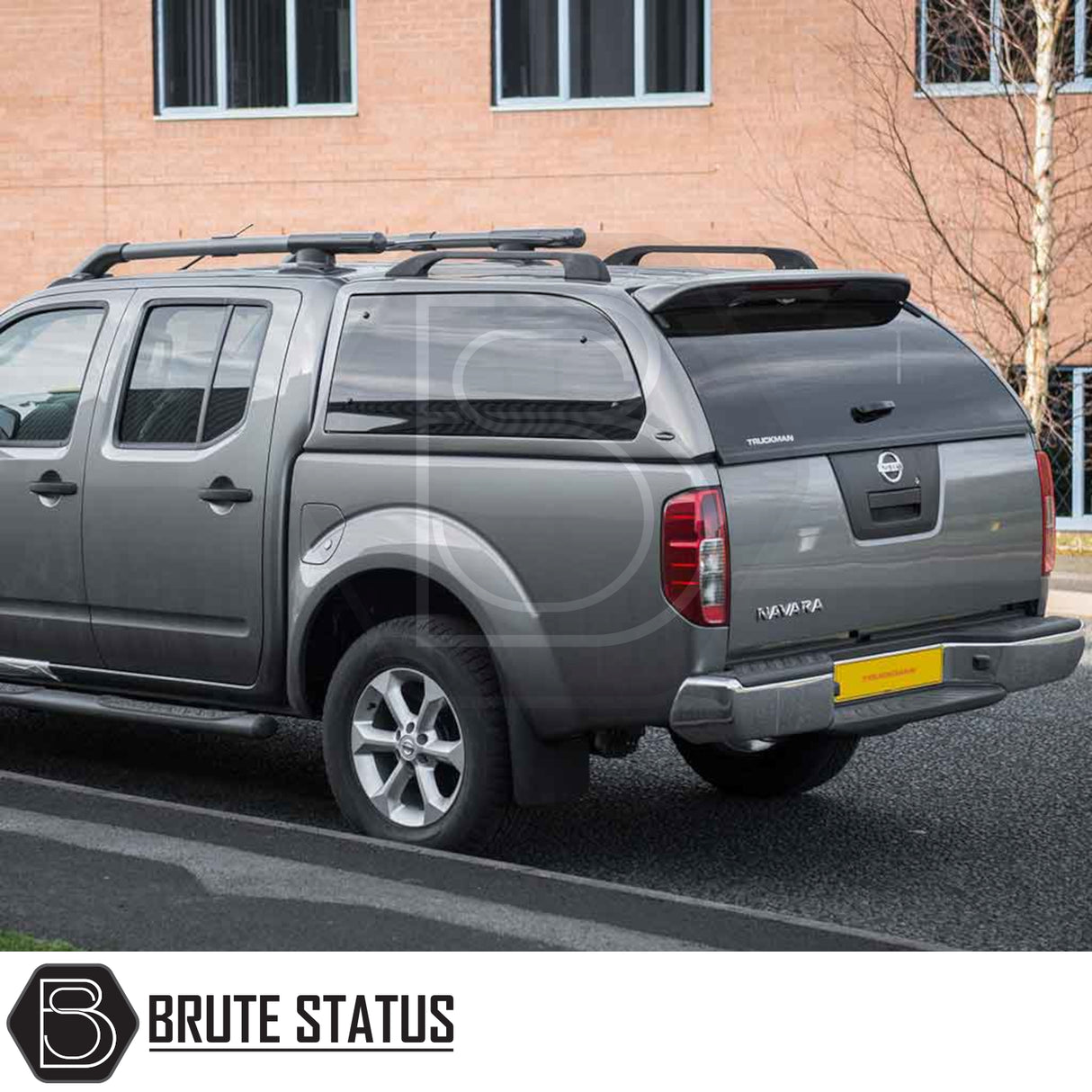 Nissan Navara 2005-2015 D40 Truckman Grand Hardtop Canopy with remote locking, featuring tinted windows and roof rails, enhancing storage and security.