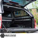 Nissan Navara 2005-2015 D40 Truckman Grand Hardtop Canopy with open hatch and empty bed liner, showcasing remote locking and aerodynamic design features.