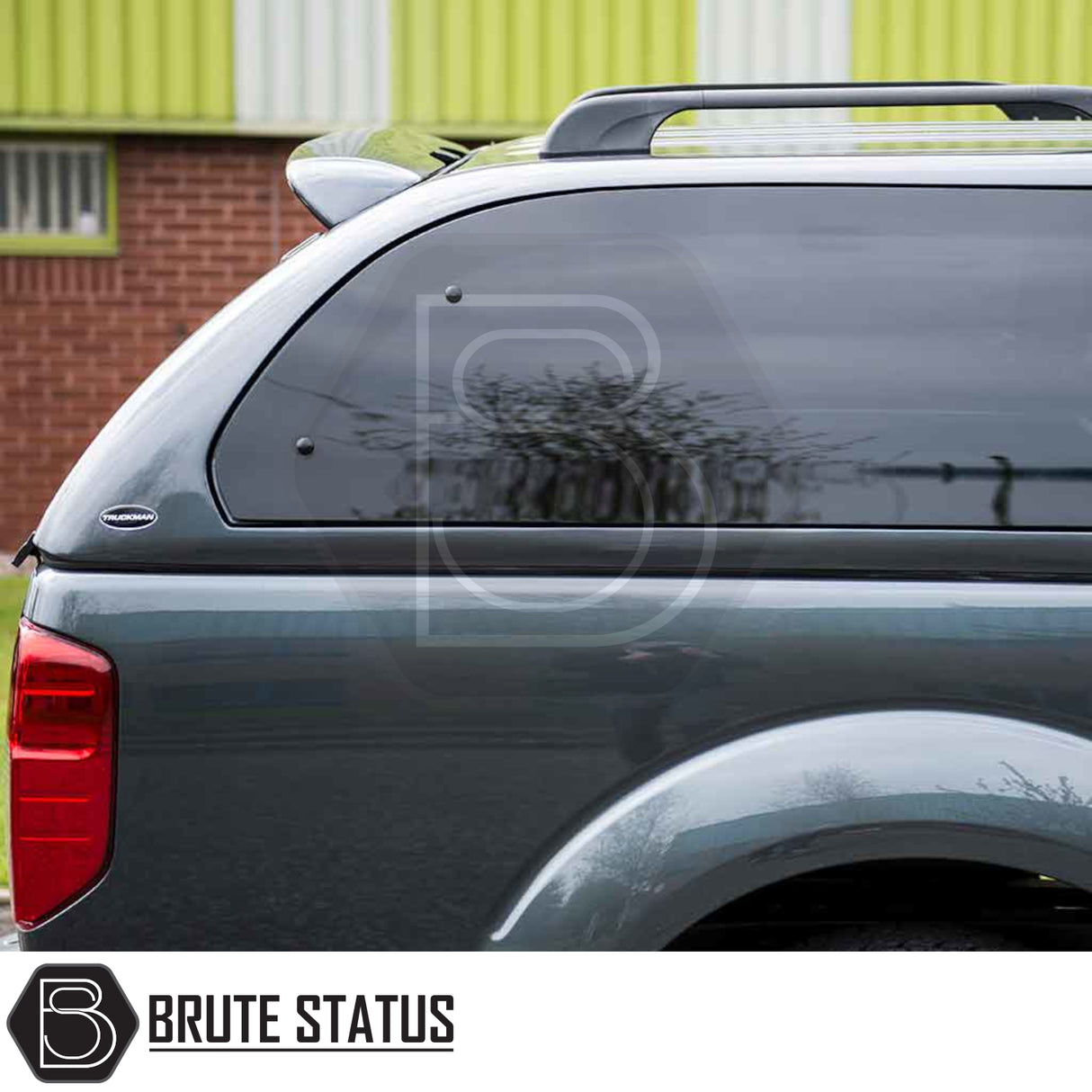 Nissan Navara 2005-2015 D40 Truckman Grand Hardtop Canopy with remote locking, tinted pop-out windows, and roof rails, enhancing storage and security.