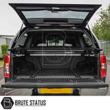 Nissan Navara 2005-2015 D40 Truckman Grand Hardtop Canopy, rear view, reveals empty bed with molded bed-liner and open hardtop, showcasing premium features.