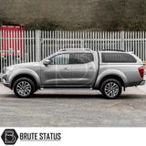 Nissan Navara 2005-2015 D40 Truckman Grand Hardtop Canopy with remote locking, featuring cab-high design and pop-out tinted windows, on a parked silver pickup.