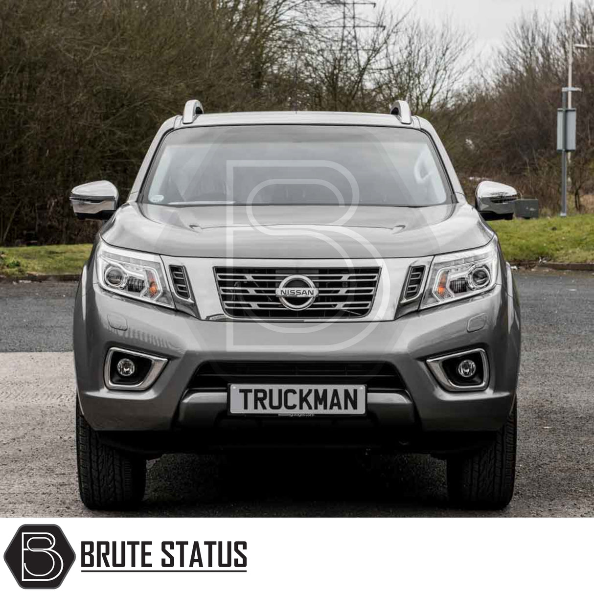 Silver Nissan pickup with Truckman Grand Hardtop Canopy, featuring pop-out windows and remote locking. Outdoor shot with Brute Status branding visible.
