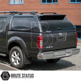Nissan Navara 2005-2015 D40 Truckman L-Series Hardtop Canopy with remote locking, enhancing storage and security, fitted on a black pickup parked by a brick building.