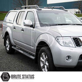 Nissan Navara 2005-2015 D40 with Truckman L-Series hardtop canopy, featuring aftermarket roof racks and Brute Status branding, parked on a paved surface.