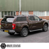 Nissan Navara 2015-2023 NP300 with a Truckman GLS hardtop canopy, featuring remote locking and sliding windows, parked beside a brick building.