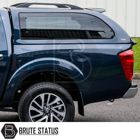 Nissan Navara NP300 Truckman Grand Hardtop Canopy with remote locking, featuring a cab-high design, tinted windows, and enhanced aerodynamics. Rear quarter view with Truckman logo.