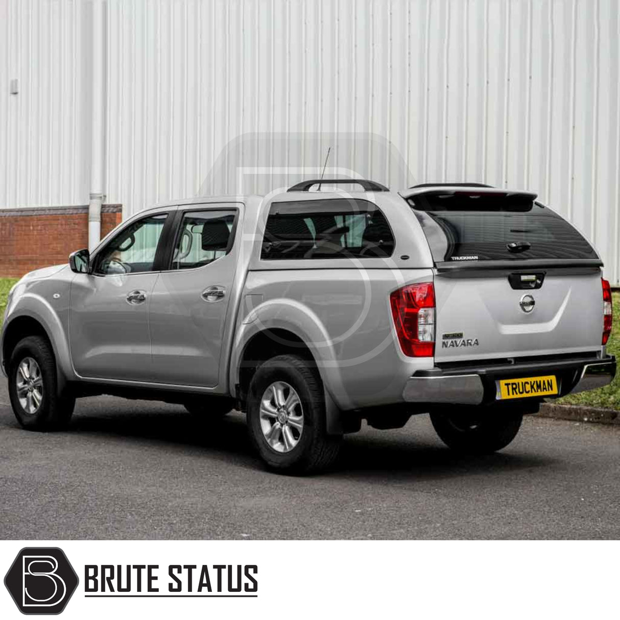 Nissan Navara 2015-2023 NP300 Truckman Grand Hardtop Canopy with remote locking shown on a parked pickup truck, featuring tinted windows and pop-out side ventilation.