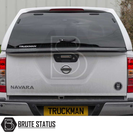 Nissan Navara 2015-2023 NP300 Truckman RS Hardtop Canopy, featuring a black design with glazed rear window and remote locking, installed on a white pickup truck.