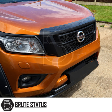 Front mounting matte black grille with Navara lettering fitted to orange Nissan Navara NP300 pickup truck offroad 4x4 vehicle. 