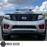 Smooth matte strong ABS black fog light surrounds fitted to silver Nissan Navara NP300 pickup truck offroad 4x4 vehicle. 