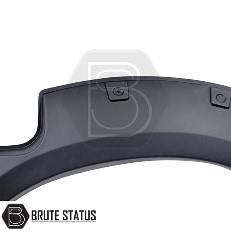 Toyota Hilux 2005–2011 wide wheel arch kit in a riveted fender-flare style. The kit includes textured black, UV-resistant plastic arches with decorative rivet bolts, adding about 65–70 mm of extra width per side. Designed for double-cab, pre-facelift Hilux models, the arches install with 3M adhesive and existing mounting points without drilling.