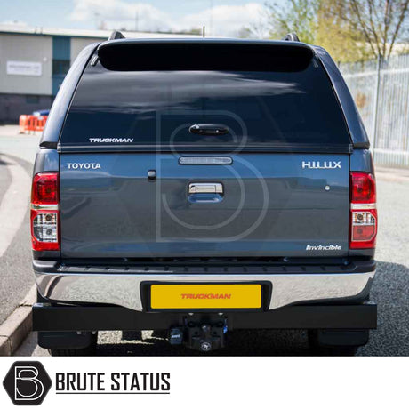 Toyota Hilux 2005-2016 MK6, MK7 Truckman GLS Hardtop Canopy with tinted rear window, chrome bumper, and tow hitch on a grey Hilux, showcasing secure, lockable features.