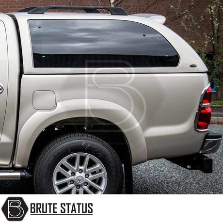 Toyota Hilux 2005-2016 Truckman Grand Hardtop Canopy with tinted window, alloy wheel, and remote locking. Enhances storage and security. Brute Status watermark visible.