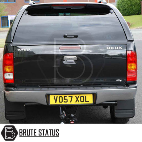 Toyota Hilux 2005-2016 MK6, MK7 Truckman Grand Hardtop Canopy with remote locking, shown from rear with canopy, tow hitch, and tinted windows.