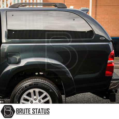Toyota Hilux 2005-2016 Truckman Grand Hardtop Canopy with tinted side window, roof rails, and Brute Status logo, showcasing premium, secure, and stylish truck enhancement.