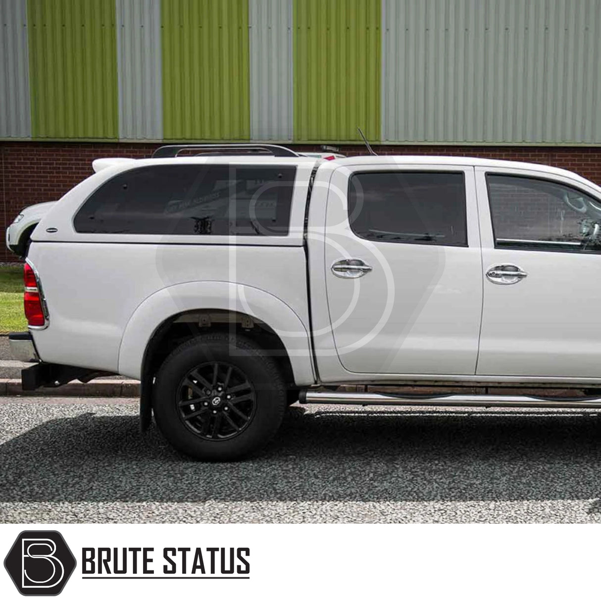 Toyota Hilux 2005-2016 Truckman Grand Hardtop Canopy with remote locking, showcased on a white pickup with black wheels, featuring seamless roof integration.