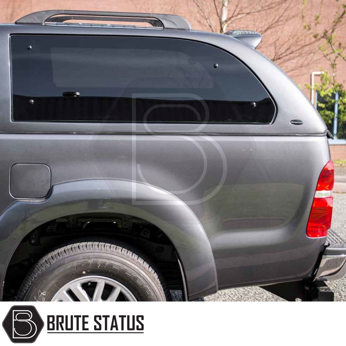Toyota Hilux 2005-2016 Truckman Grand Hardtop Canopy with tinted windows and Brute Status logo, showcasing remote locking and luxury features for enhanced truck functionality.
