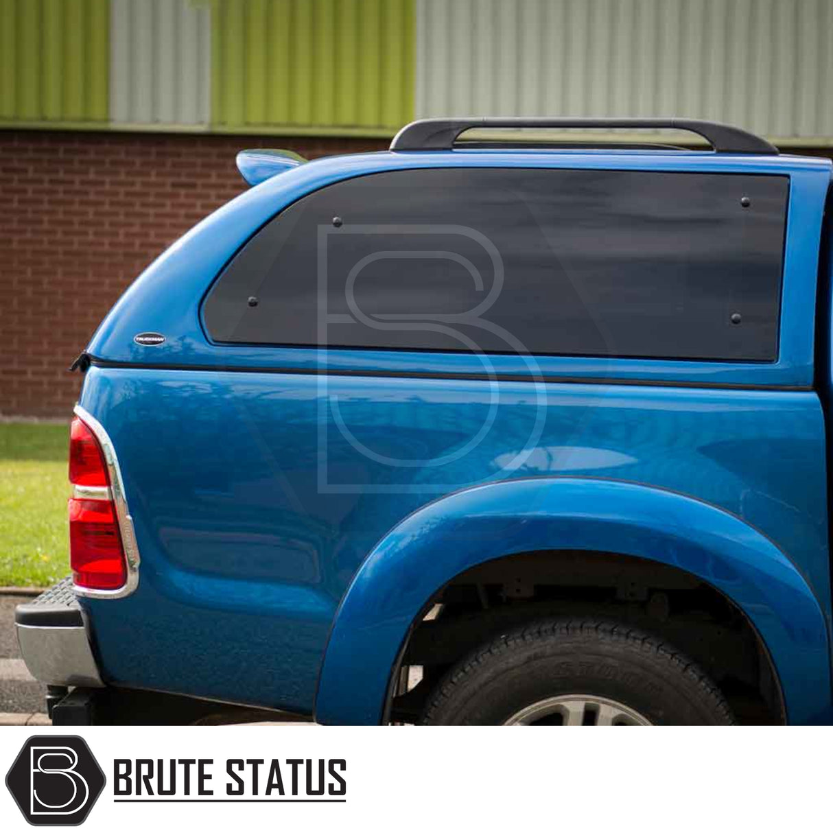 Toyota Hilux 2005-2016 Truckman Grand Hardtop Canopy with remote locking, featuring dark-tinted pop-out side windows and roof rack. Brand: Brute Status.