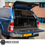 Rear view of a Toyota Hilux 2005-2016 featuring a Truckman Grand Hardtop Canopy with remote locking, showcasing the open, lined cargo bed.