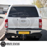 Rear view of silver Toyota Hilux with a Truckman RS Hardtop Canopy, featuring a glazed rear window and tow hitch, showcasing enhanced security and durability.