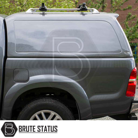 Toyota Hilux 2005-2016 Truckman RS Hardtop Canopy with Thule roof-rack on dark grey pickup, showcasing secure, aerodynamic design for enhanced cargo protection.