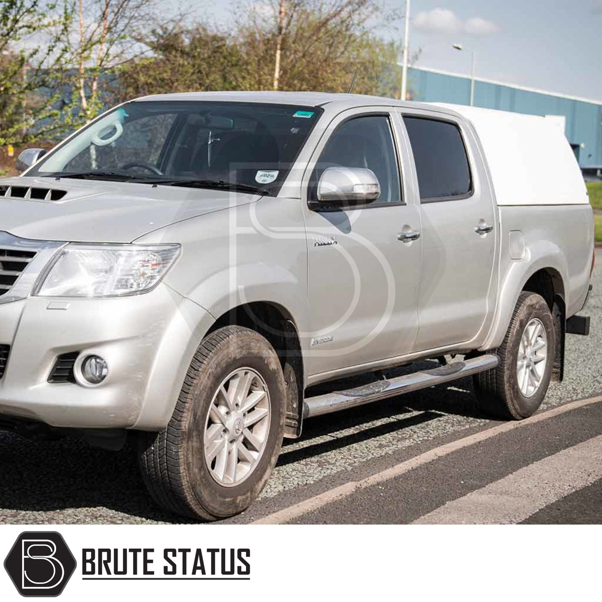Silver Toyota Hilux with Truckman RS hardtop canopy featuring a glazed rear window, offering enhanced security and versatility for commercial use.