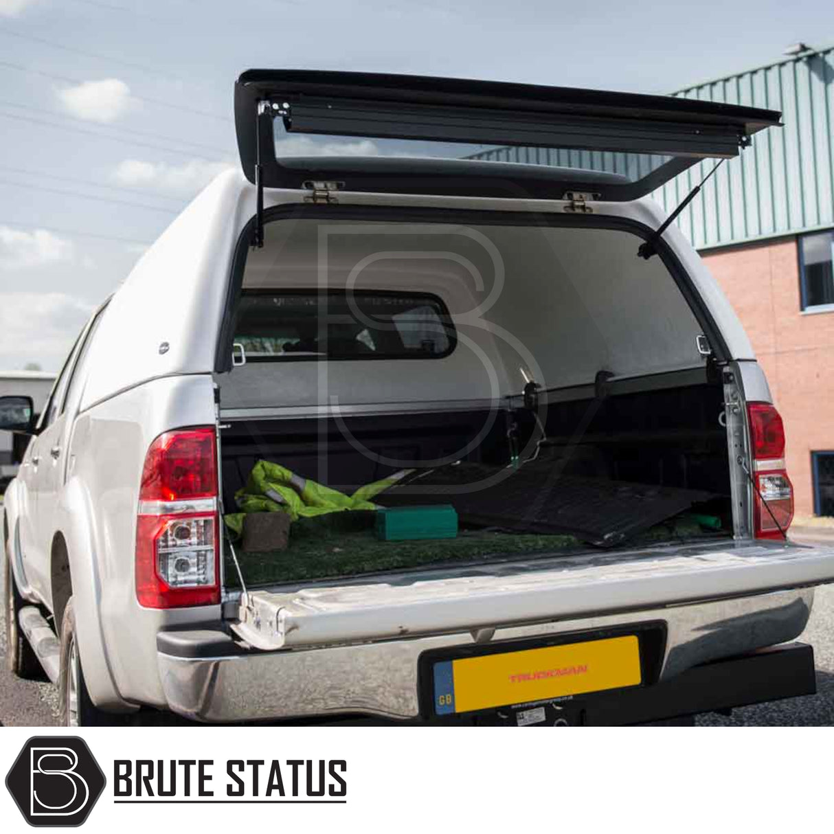 Toyota Hilux 2005-2016 MK6, MK7 Truckman RS Hardtop Canopy with glazed rear window shown open, revealing truck-bed interior and accessories.